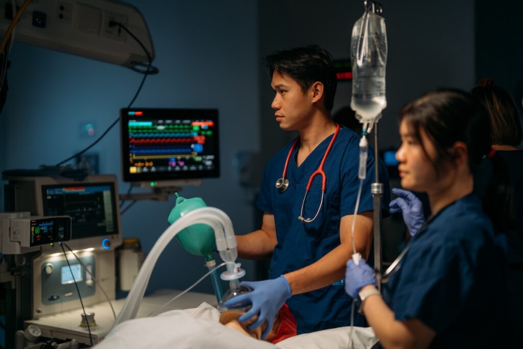 medical students in a hospital room with a dummy patient