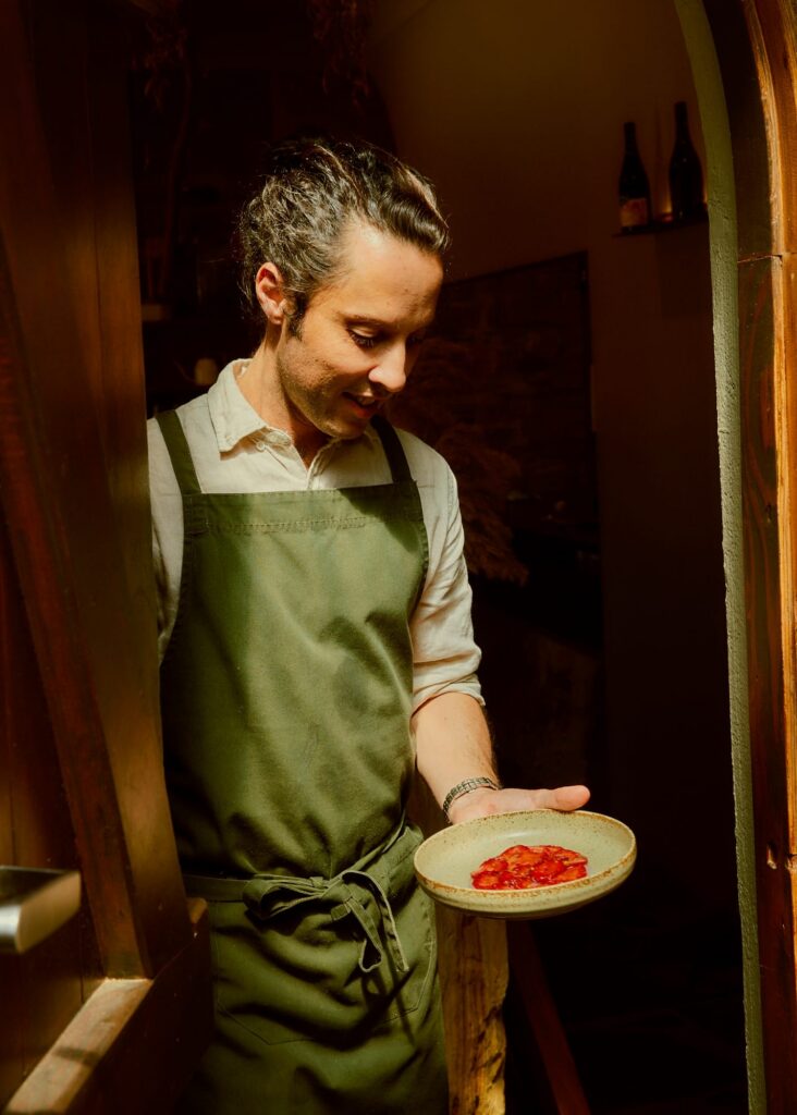 Chef holding a dish at a restaurant