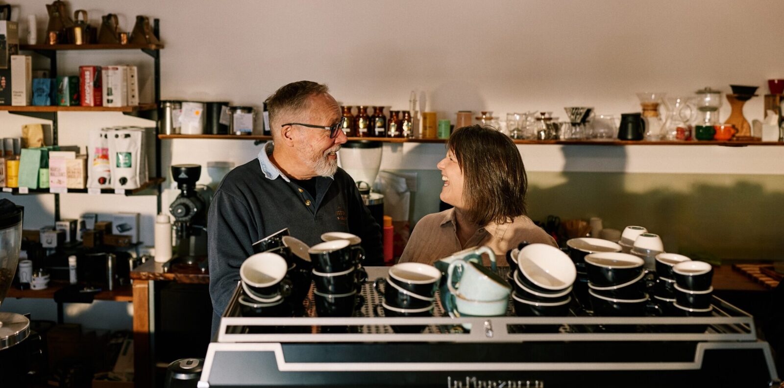 Richard and Sue behind the coffee machinge at the Boston Bean Company