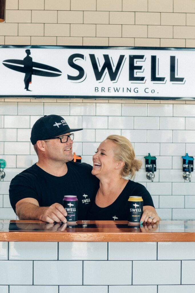 Staff members behind the bar at Swell brewery