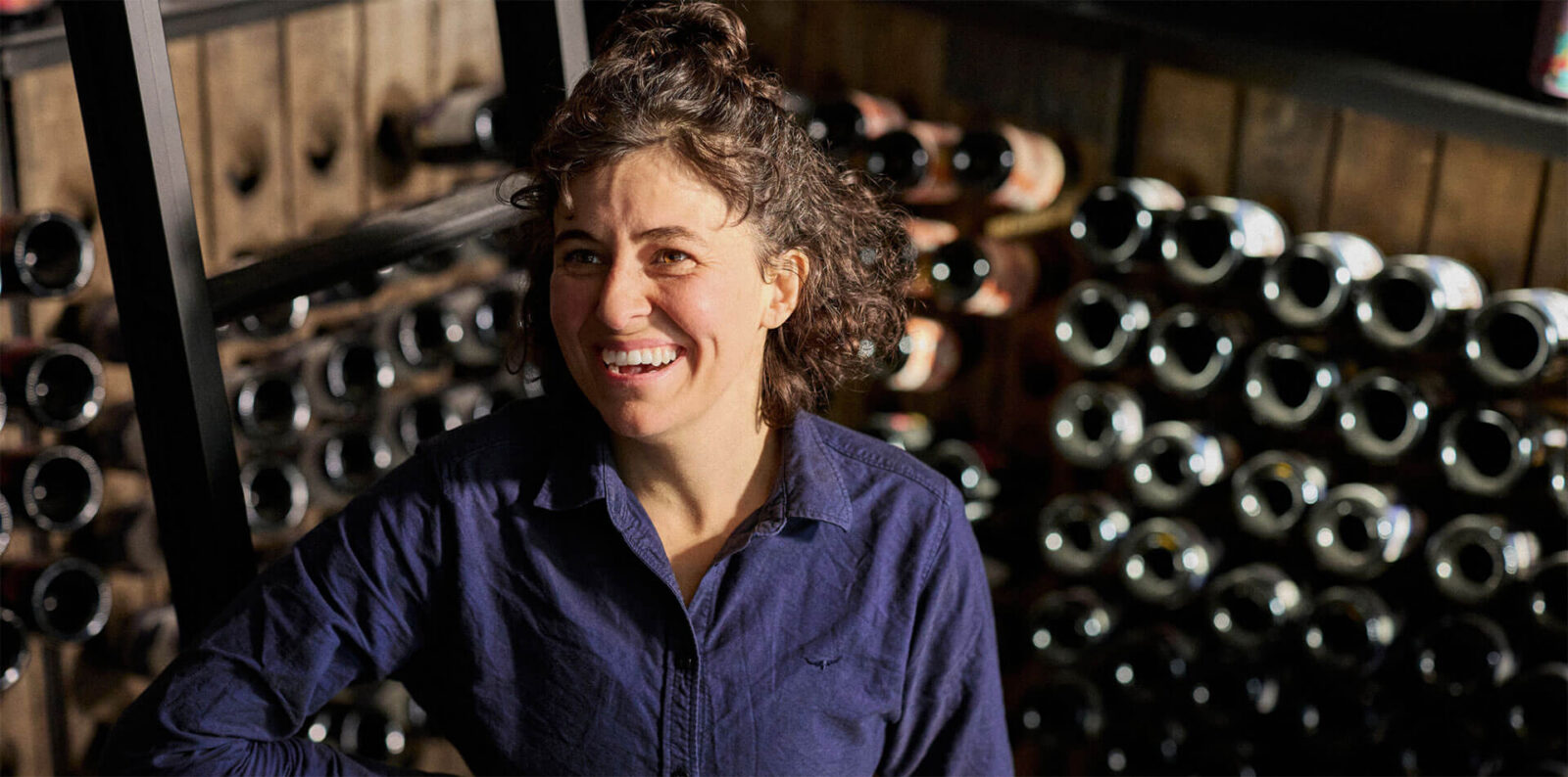 lady smiling in a wine cellar