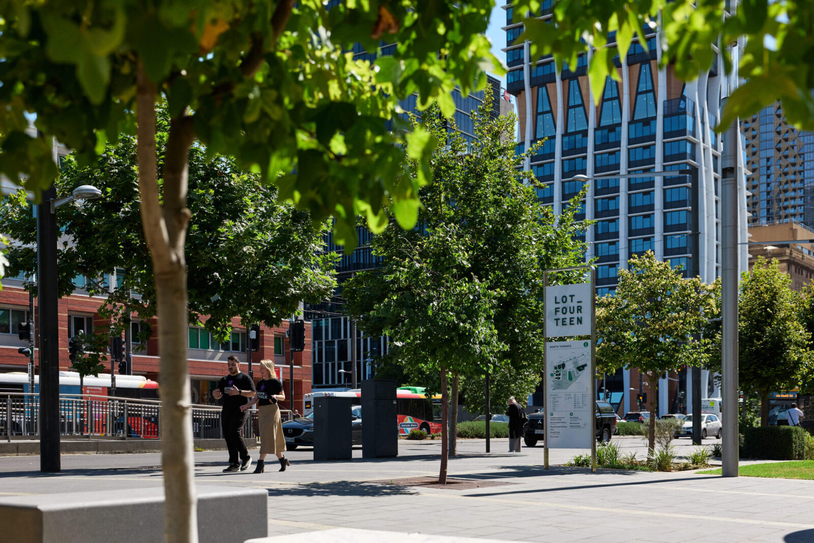 Wide shot of the North Terrace Lot Fourteen precinct with people walking by